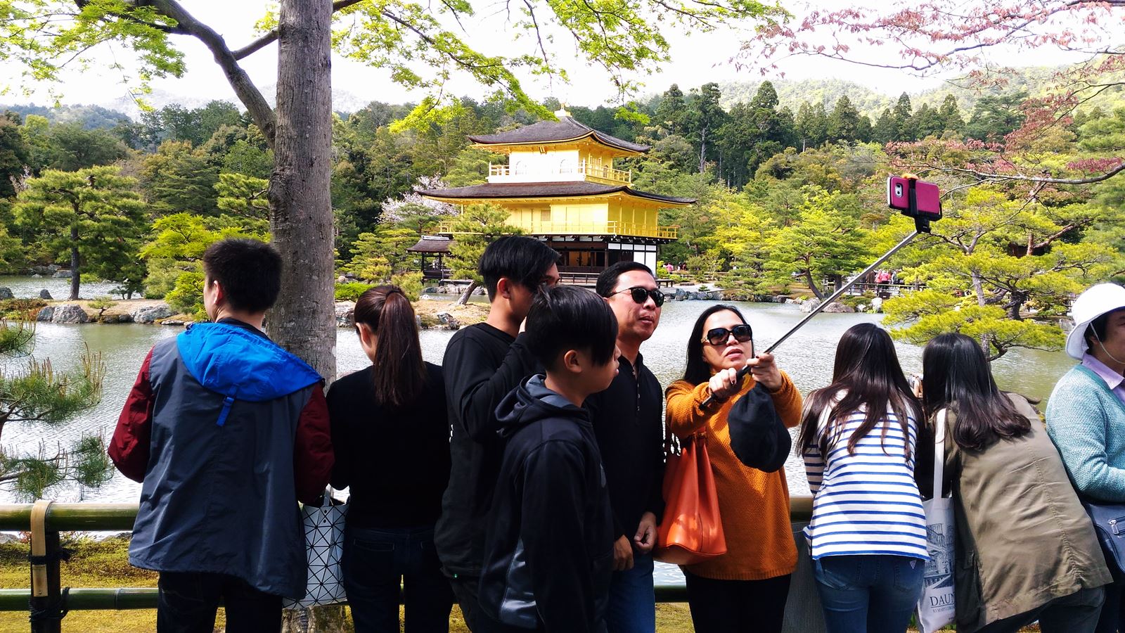 Chinese tourists visiting the Golden Temple in Kyoto, Japan.