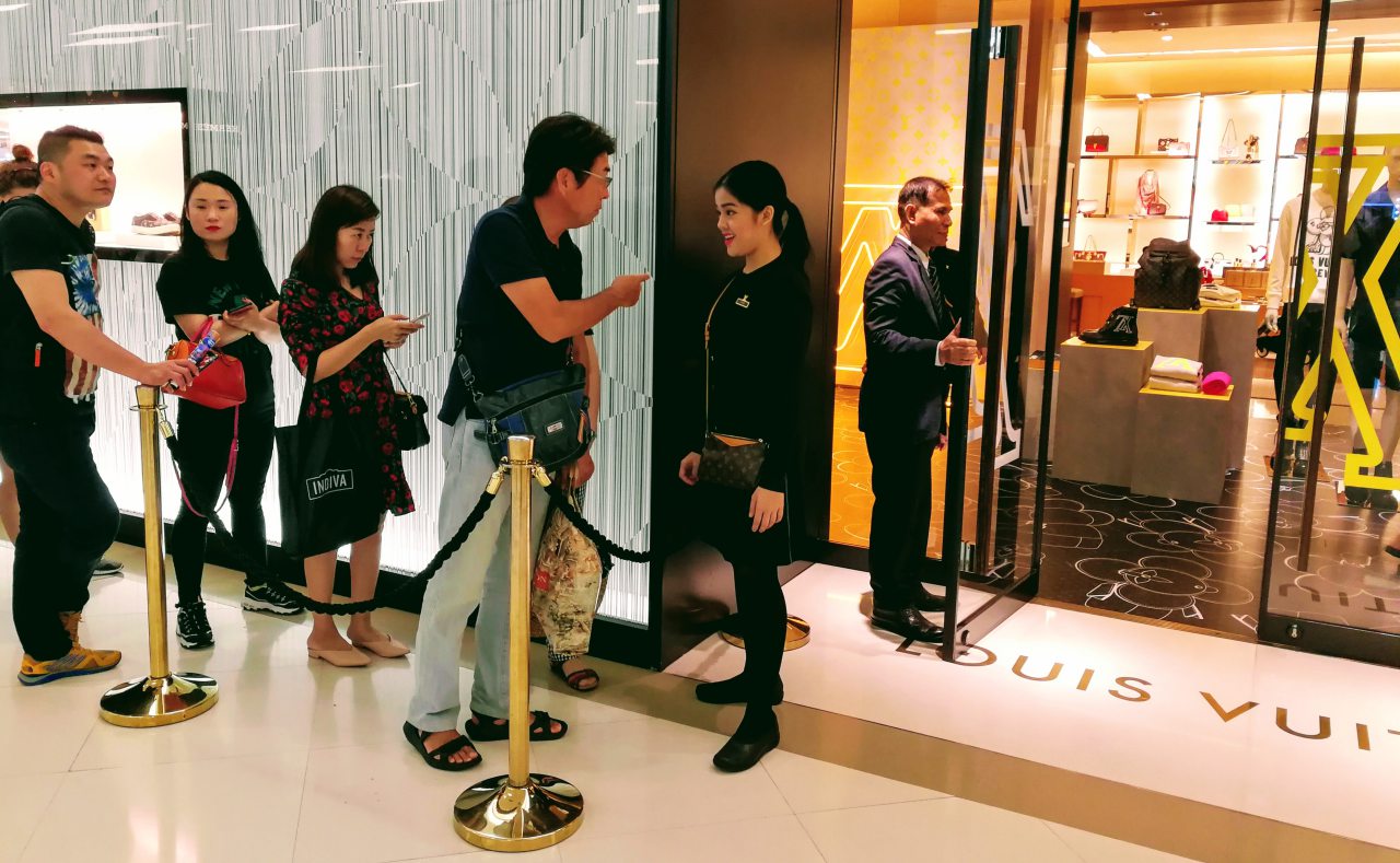 Tourists are queuing in front of a luxury outlet in Bangkok