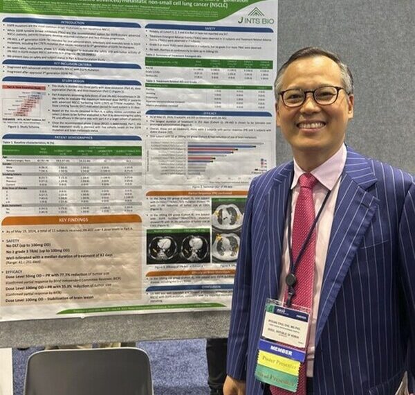 Professor Cho, Byoung Chul posing with the JIN-A02 poster at the 2024 ASCO Chicago USA